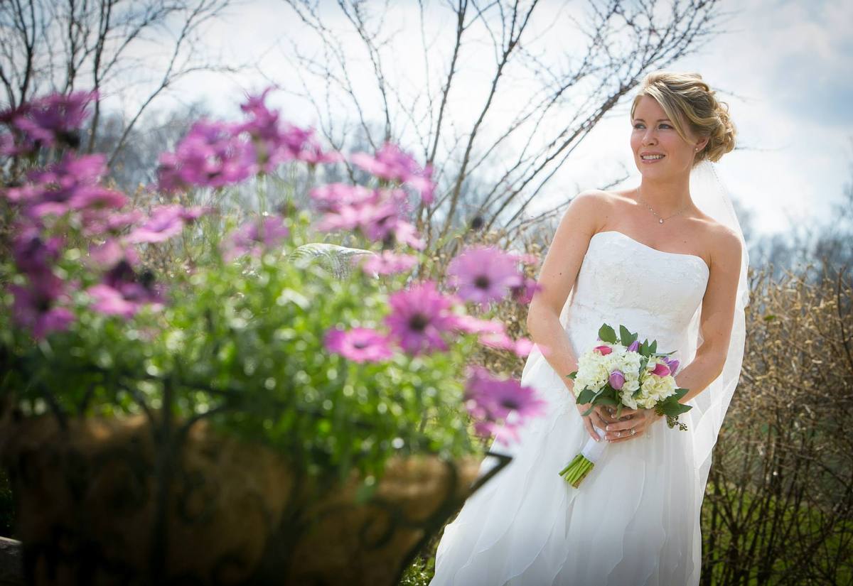 A bride with her bouquet on the grounds