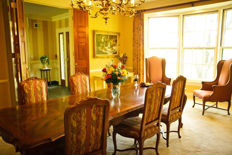The formal dining room, set beneath its chandelier
