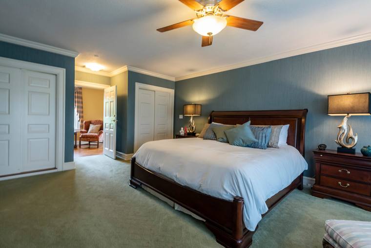 A bedroom inside the Estate House, furnished with antiques