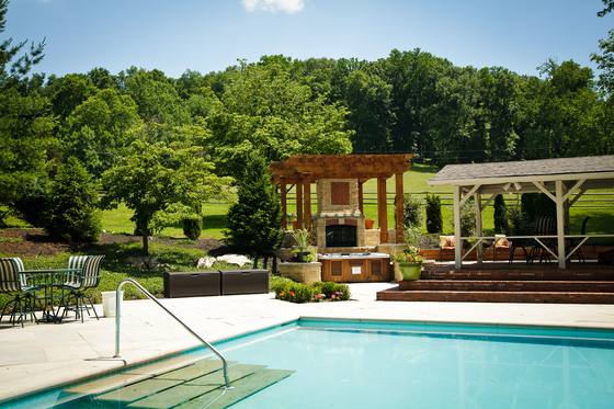 The pergola beside the pool, with loungers in the shade